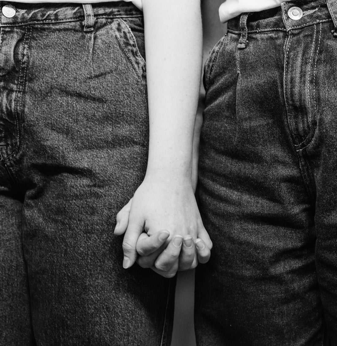 Two people holding hands