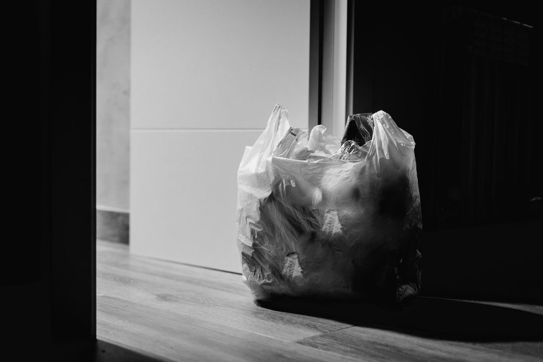 Full plastic trash bag on floor